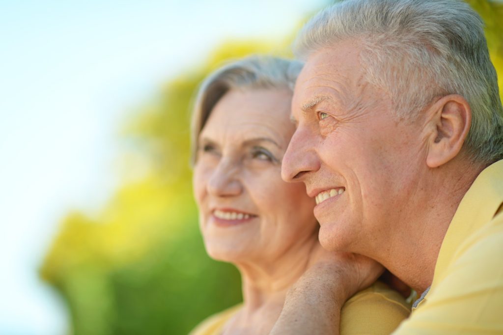 Portrait of beautiful elderly couple outdoor in summer park
